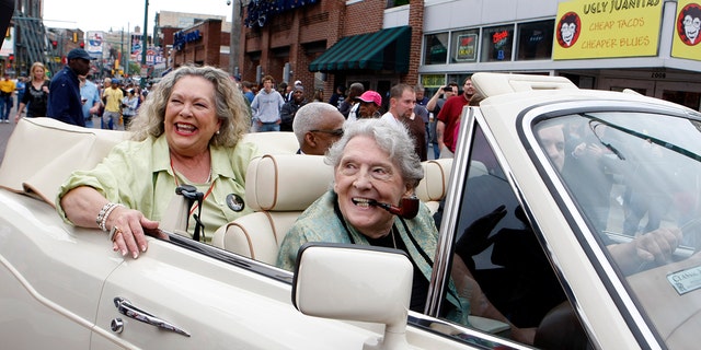Jerry Lee Lewis greets fans with seventh wife Judith Brown during a parade down Beale Street in Memphis, Tennessee, on April 27, 2013.