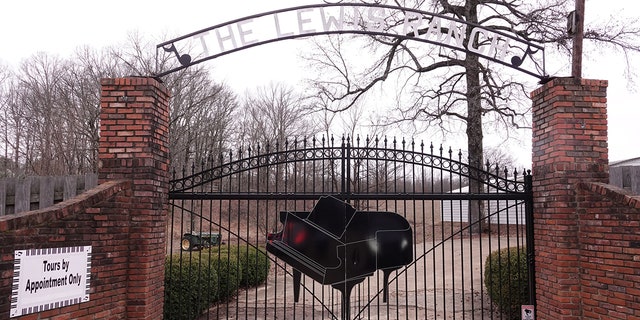 The front gate outside the Mississippi home of late entertainer Jerry Lee Lewis features a massive piano.