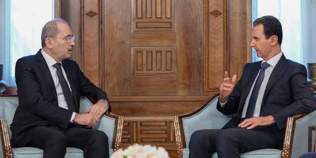Syrian President Bashar Assad, right, meets Jordanian Foreign Minister Ayman Safadi in Damascus, Syria, on Feb. 15, 2023. Safadi vowed to continue delivering earthquake aid to Syria during the meeting with Assad in Damascus.