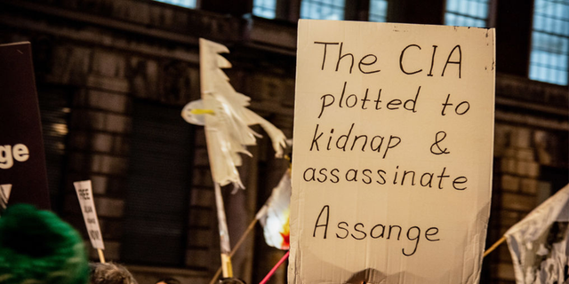 A protester holds a placard during the Julian Assange procession in London to protest against his continued imprisonment. 
