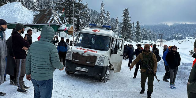 An ambulance leaves with the bodies of two foreign skiers who were killed in an avalanche in Indian-controlled Kashmir, on Feb. 1, 2023. 