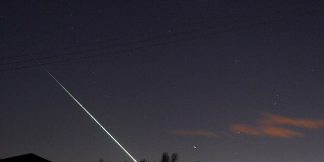 FILE PHOTO: A meteorite creates a streak of light across the night sky over the North Yorkshire moors at Leaholm, near Whitby, northern England.