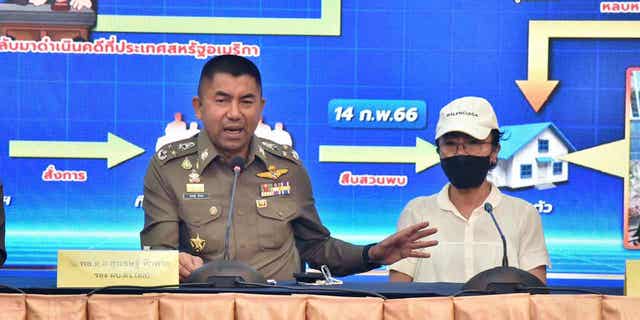 Deputy National Police Chief Surachet Hakpal, left, talks to reporters with Tubtim "Sue" Howson, 57, during press conference at police headquarter in Bangkok, Thailand, Wednesday, Feb. 15, 2023. Howson allegedly struck Michigan State University student Benjamin Kable, 22, shortly before dawn on Jan. 1. She flew to Thailand on a one-way ticket on Jan. 3, according to U.S. authorities. (Royal Thai Police via AP)