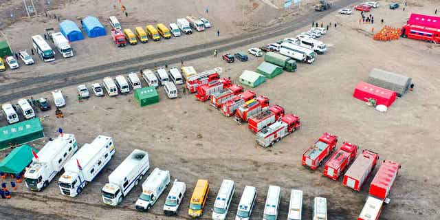 Rescue vehicles are parked near the site of a collapsed open pit coal mine in the Inner Mongolia Autonomous Region on Feb. 23, 2023. Five people were confirmed dead from the collapse.