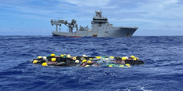 Bags of cocaine, said to be recovered by New Zealand Police, Customs and the New Zealand Defence Force at sea, are seen in a net floating in the Pacific Ocean, in this undated handout image released on Feb. 8, 2023.