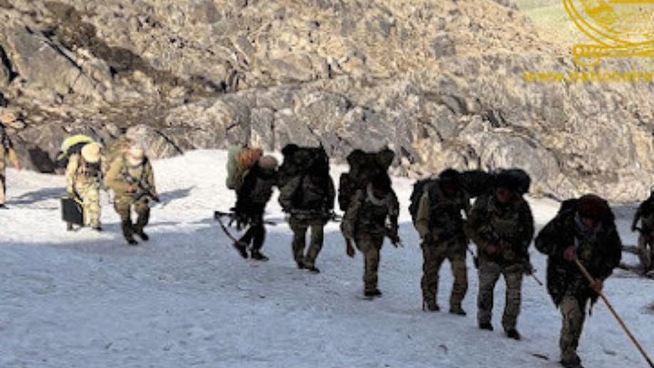 NRF fighters stand on the snowy mountains of Afghanistan