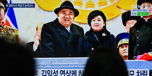North Korean dictator Kim Jong Un attends a military parade with his daughter.