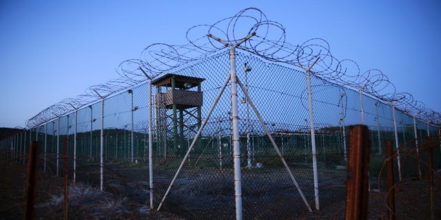 Chain link fence and concertina wire surrounds a deserted guard tower within Joint Task Force Guantánamo's Camp Delta at the U.S. Naval Base in Guantánamo Bay, Cuba, in 2016.