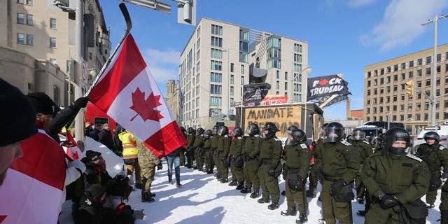 Police move a line of protesters from the intersection at Sussex and Rideau Streets in Ottawa on Feb. 18, 2022.
