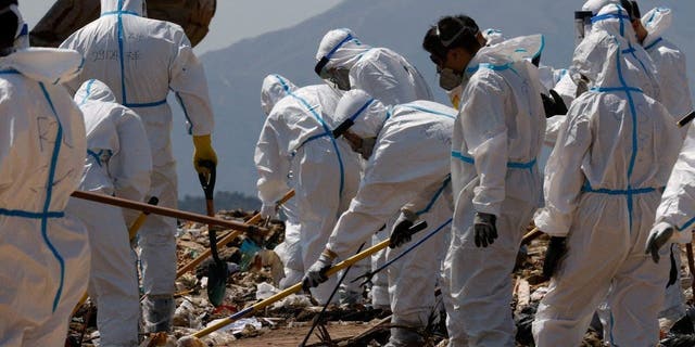 Police excavate a landfill during a search for the missing parts of 28-year-old model Abby Choi's body in Hong Kong, China Feb. 28, 2023. 