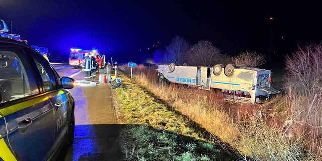 A bus belonging to a tour company from Poland lies on its roof after an accident near Bornstedt, Germany, on Feb. 10, 2023. 
