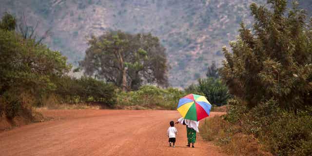 A mother reaches out to hold the hand of her young daughter, as they walk home after a church service in Rwanda on Sept. 6, 2015. The Protestant Council of Rwanda has directed health facilities run by its members to stop carrying out abortions.