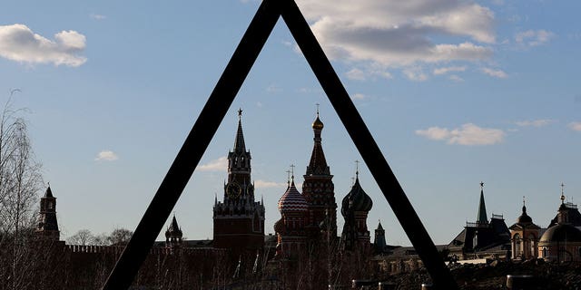 The Kremlin's Spasskaya Tower and St. Basil's Cathedral in Moscow.