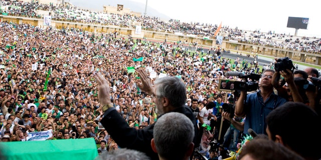 Mir Hossein Mousavi, a reformist candidate in Iran's presidential elections in 2009, waves to supporters during a campaign rally in Karaj, Iran on June 6, 2009. (Ramin Talaie/Corbis via Getty Images)