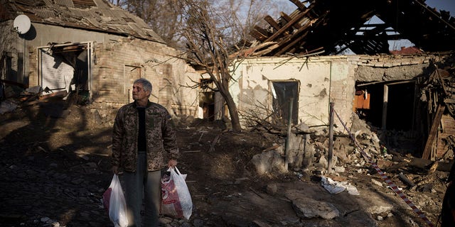 Anatolii Kaharlytskyi, 73, stands near his house, heavily damaged after a Russian attack in Kyiv, Ukraine, Monday, Jan. 2, 2023. Kaharlytskyi was injured, and his daughter-in-law Iryna died in the attack on Dec. 31, 2022.