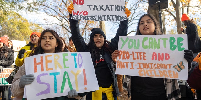 Protestors hold Pro-DACA signs during a protest in Washington, D.C.