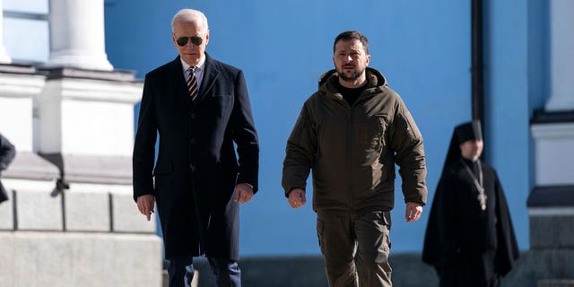 President Biden (L) walks with Ukrainian President Volodymyr Zelenskyy (R) at St. Michael's Golden-Domed Cathedral during an unannounced visit, in Kyiv on February 20, 2023.
