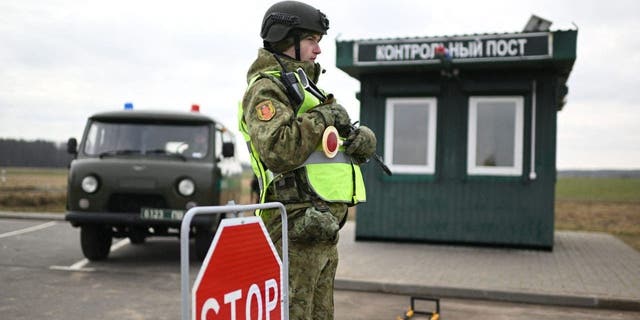 Belarusian border guards check drivers and vehicles near the frontier with Ukraine in the Brest region on Feb. 15, 2023.