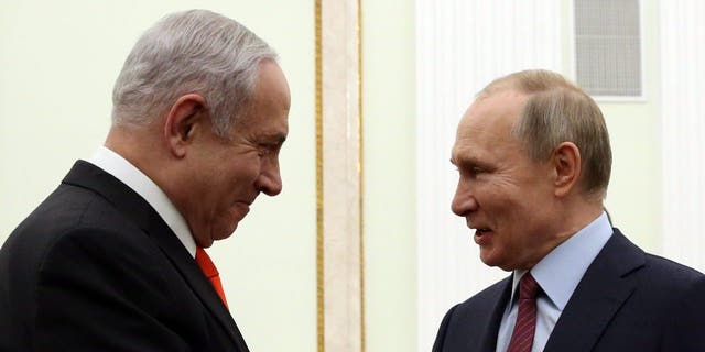 FILE - Russian President Vladimir Putin greets Israeli Prime Minister Benjamin Netanyahu during their meeting at the Kremlin on Jan. 30, 2020, in Moscow, Russia. 