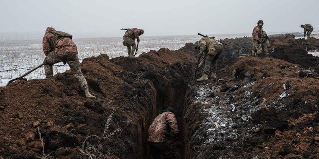 Ukrainian servicemen dig a trench near Bakhmut on Feb. 1, 2023. 