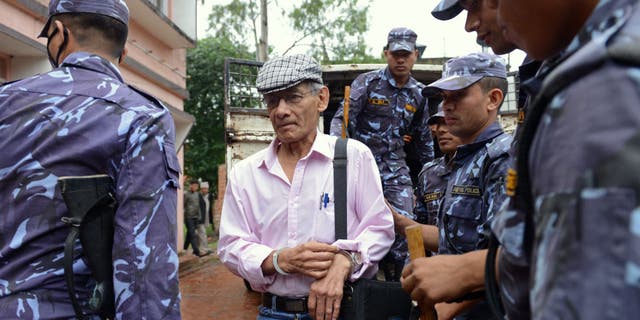 French serial killer Charles Sobhraj, center, is brought to the district court for a hearing on a case related to the murder of Canadian backpacker Laurent Ormond Carriere, in Bhaktapur on May 26, 2014. Sobhraj, a French citizen who is serving a life sentence in Nepal for the murder of an American backbacker in 1975, has been linked with a string of killings across Asia in the 1970s, earning the nickname "bikini killer."