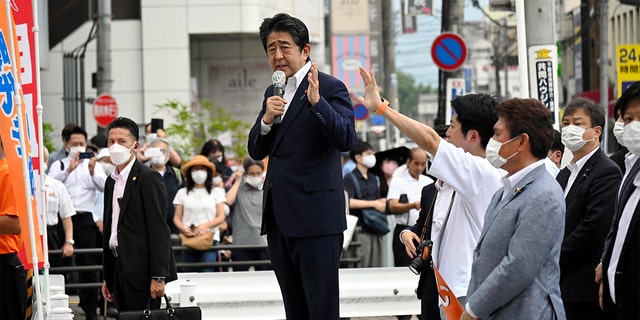 Former Japanese Prime Minister Shinzo Abe makes a speech before he was shot from behind by a man in Nara, Japan, in this photo taken by The Asahi Shimbun. Former President Trump reflected with sorrow on the former prime ministers assassination, calling him a "unifier."