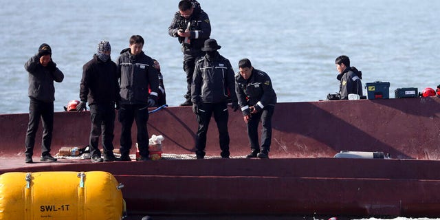 Members of a rescue team search for people from a capsized boat in waters off the country's southwestern coast, South Korea, Sunday, Feb. 5, 2023.