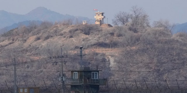 North Korean military guard posts, rear, and South Korea posts, bottom, are seen in Paju, South Korea, near the border with North Korea, Thursday, Feb. 16, 2023.
