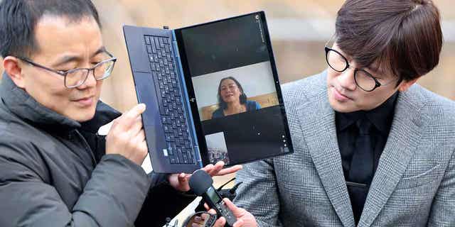 Vietnamese woman Nguyen Thi Thanh is seen on a computer monitor as she speaks outside the court in Seoul, South Korea, on Feb. 7, 2023. A South Korean court ordered the government to pay $24,000 to Nguyen Thi Thanh, who survived a gunshot wound but lost several relatives, when her village was raided during the Vietnam War.