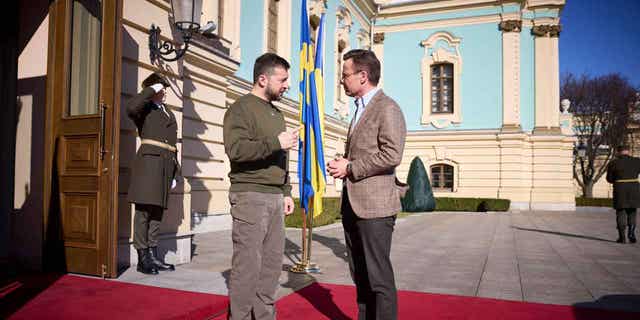 Swedish Prime Minister Ulf Kristersson, right, and Ukrainian President Volodymyr Zelenskyy talk during a meeting in Kyiv, Ukraine, on Feb. 15, 2023.