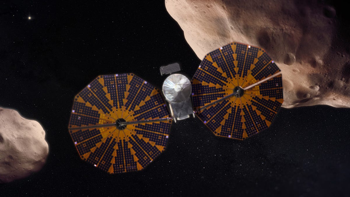 Artist's rendering of NASA's Lucy spacecraft near a pair of asteroids.