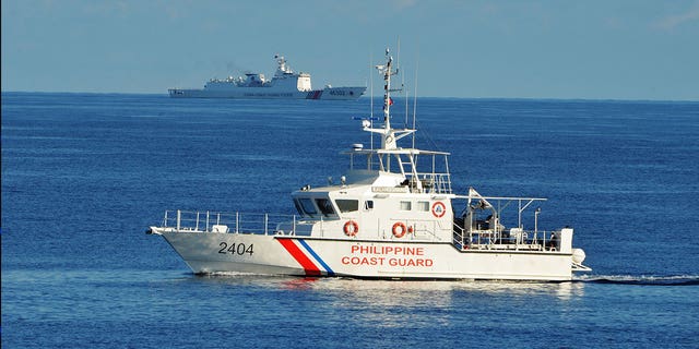 A Philippine coast guard ship sails in the South China Sea on May 14, 2019. The Filipino coast guard joined the U.S. Monday in search for a missing Taiwanese fishing vessel that was carrying six people.