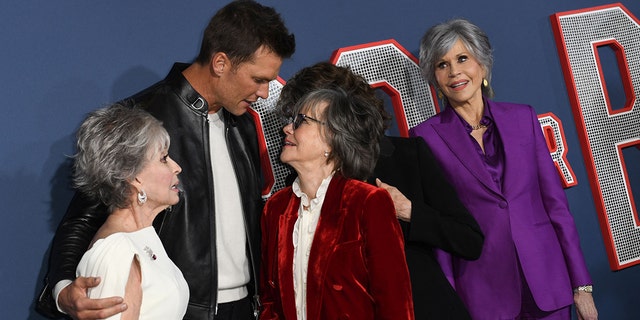 Tom Brady hugs Rita Morena and Sally Field.