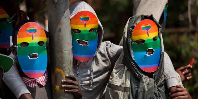 Kenyan gays, lesbians, and others supporting their cause wear masks as they stage a protest against Uganda's stance against homosexuality on Feb. 10, 2014. A Ugandan lawmaker on Feb. 28, 2023 introduced legislation that seeks to further prohibit homosexuality in the country.
