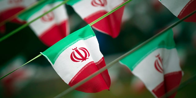 Iran's national flags are seen on a square in Tehran February 10, 2012. British diplomats have issued a warning to Iran's head of foreign affairs over recent threats against journalists by the Islamic regime.