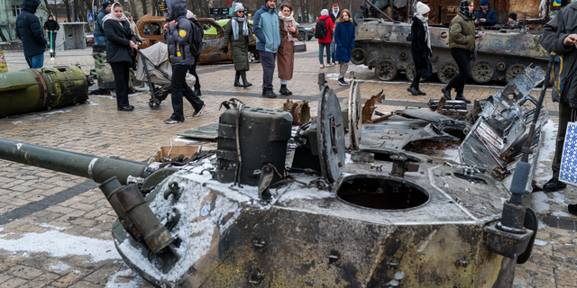 People look at destroyed Russian military vehicles on display in Kyiv on Jan. 29, 2023.
