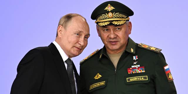 Russian President Vladimir Putin, left, vowed to strengthen Russia's military cooperation with its allies during the 2022 International Military and Technical Forum in Patriot Park outside Moscow on Aug. 15, 2022.