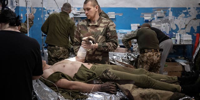 Medics treat a wounded Ukrainian soldier in the operation room of a frontline medical stabilisation point, amid Russia's attack on Ukraine, near Vuhledar, Donetsk region, Ukraine, on Feb.19, 2023