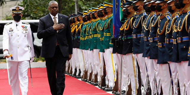 U.S. Defense Secretary Lloyd Austin, second from left, walks past military guards during his arrival at the Department of National Defense in Camp Aguinaldo military camp in Quezon City, Metro Manila, Philippines on Thursday February 2, 2023. 