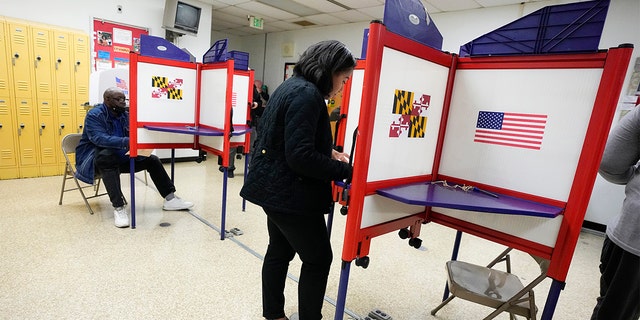 People fill out ballots during early voting at Westside Skill Center, Oct. 31, 2022, in Baltimore, Maryland. Midterm elections are being held on Tuesday, Nov. 8. 