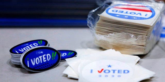 "I voted" stickers with the Seahawks logo are pictured on Election Day at a voting center set up at the CenturyLink Field Event Center for people that need to register or get other assistance in the vote-by-mail state in Seattle, Washington on November 3, 2020.