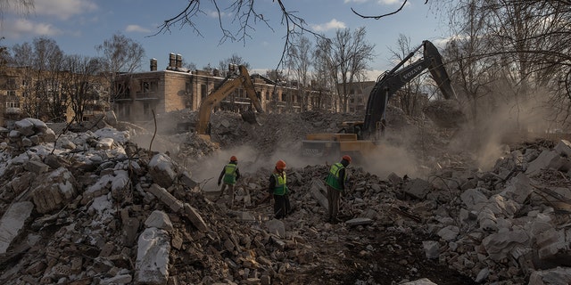 Demolition employees work on a site of a demolished residential building that was heavily damaged during Russian attacks, on Feb. 7, 2023, in Hostomel, Ukraine. 