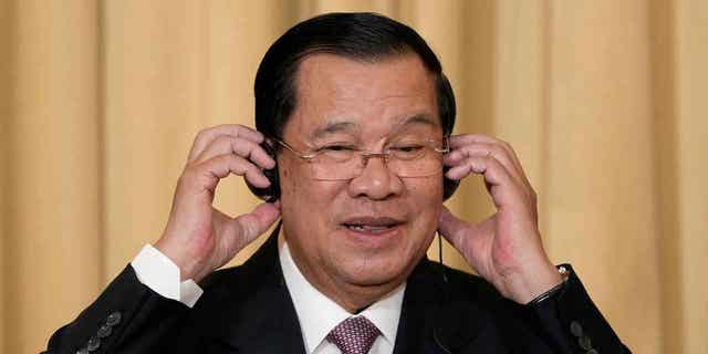 Cambodia's Prime Minister Hun Sen attends a press conference at the Elysee Palace, in Paris, on Dec. 13, 2022. Two Cambodian activists were charged with insulting the king and prime minister on social media.