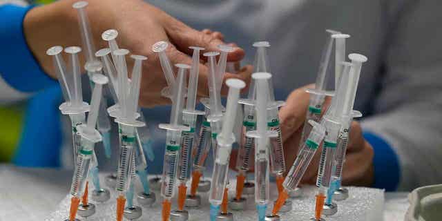 A nurse prepares COVID vaccines in the Wizink Center in Madrid, Spain, on Dec. 1, 2021. Forty-two families in Spain’s Basque Country are pursuing legal action against a nurse who allegedly faked the process of administering vaccines to their children.