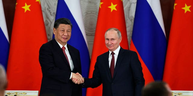 Russian President Vladimir Putin, right, and Chinese President Xi Jinping shake hands following their talks at The Grand Kremlin Palace, in Moscow, Russia, on March 21, 2023. 