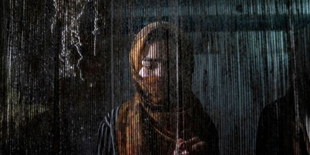 An Afghan woman weaves a carpet at a traditional carpet factory in Kabul, Afghanistan, on March 6, 2023. After the Taliban came to power in Afghanistan, women have been deprived of many basic rights. 