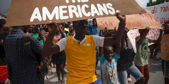 People protest for the release of kidnapped missionaries near the Ohio-based Christian Aid Ministries headquarters in Titanyen, north of Port-au-Prince, Haiti, Tuesday, Oct. 19, 2021. 