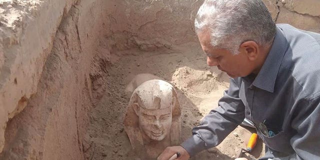 This undated photo distributed on March 6, 2023, shows a sphinx statue believed to be made to replicate a Roman emperor. The statue is being uncovered from an archaeological site in Qena, Egypt.