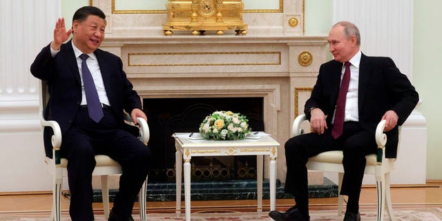 Chinese President Xi Jinping gestures while speaking to Russian President Vladimir Putin during their meeting at the Kremlin in Moscow, Russia, Monday, March 20, 2023.