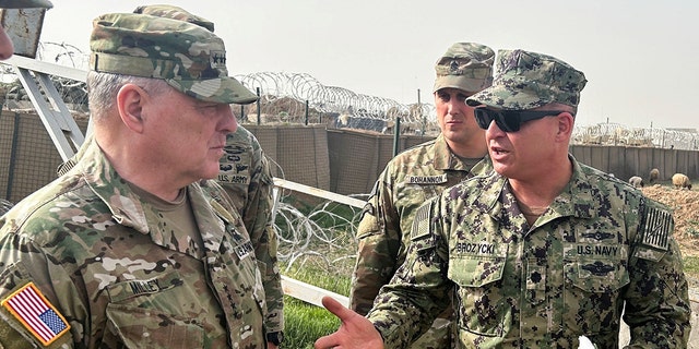 U.S. Joint Chiefs Chair Army General Mark Milley, left, speaks with U.S. forces in Syria during an unannounced visit, at a U.S. military base in Northeast Syria, March 4, 2023.